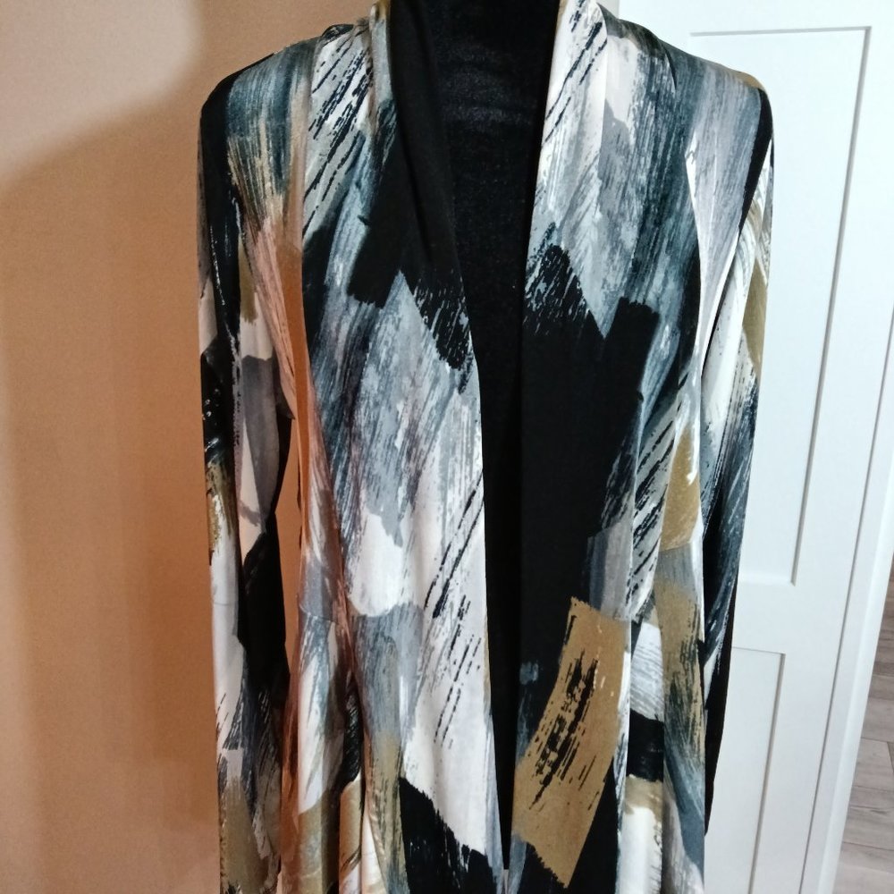 A new classic mid cut draped jacket covered in a rich brushstroke print .